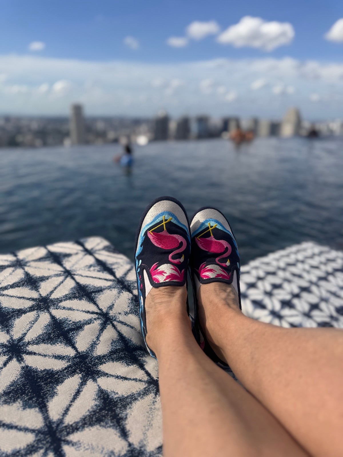 Infinity pool with flamingo slip-ons