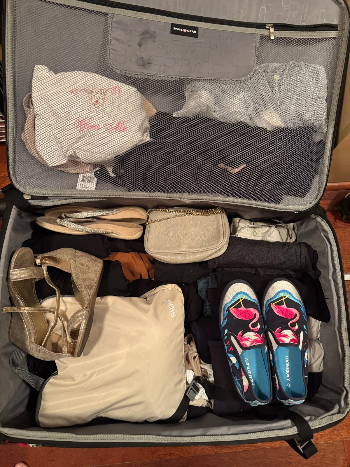 Suitcase packed with Wanderwell slip-ons